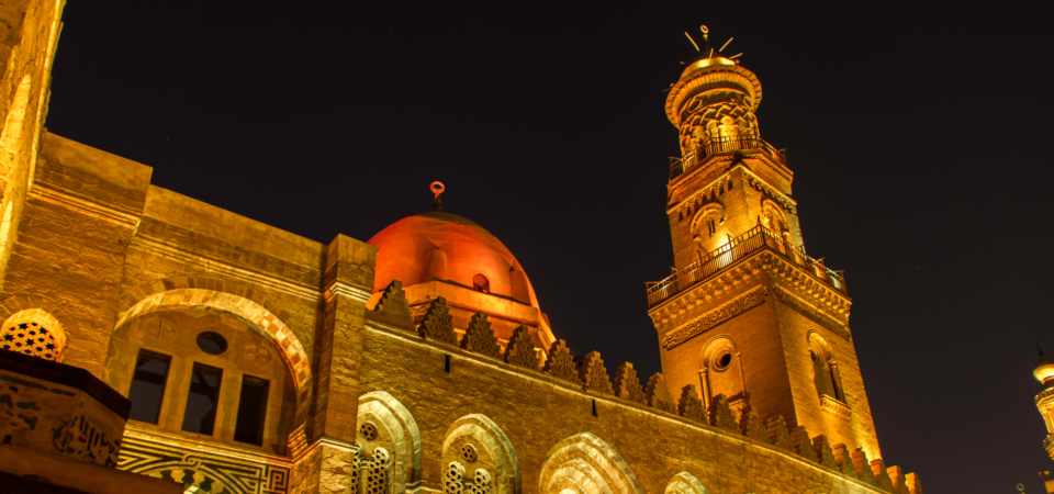 Night view of the Complex of Sultan Qalawun, illuminated against the dark sky.