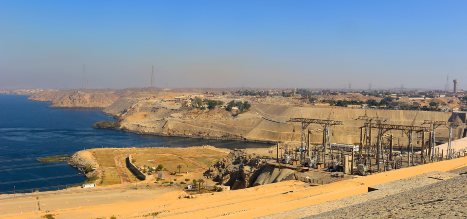 A wide view of the High Dam in Aswan, spanning the Nile River.