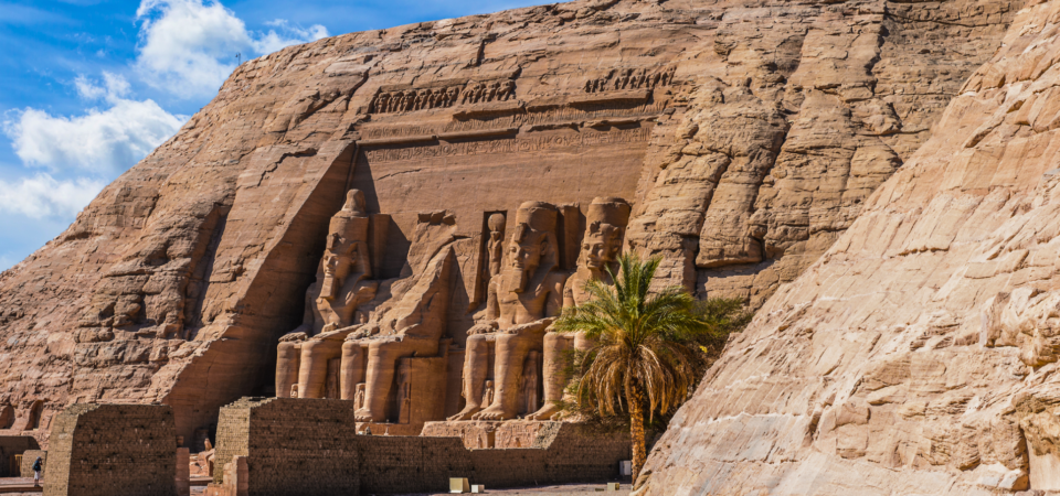 The grand façade of Abu Simbel Temple featuring four colossal statues of Pharaoh Ramses II.