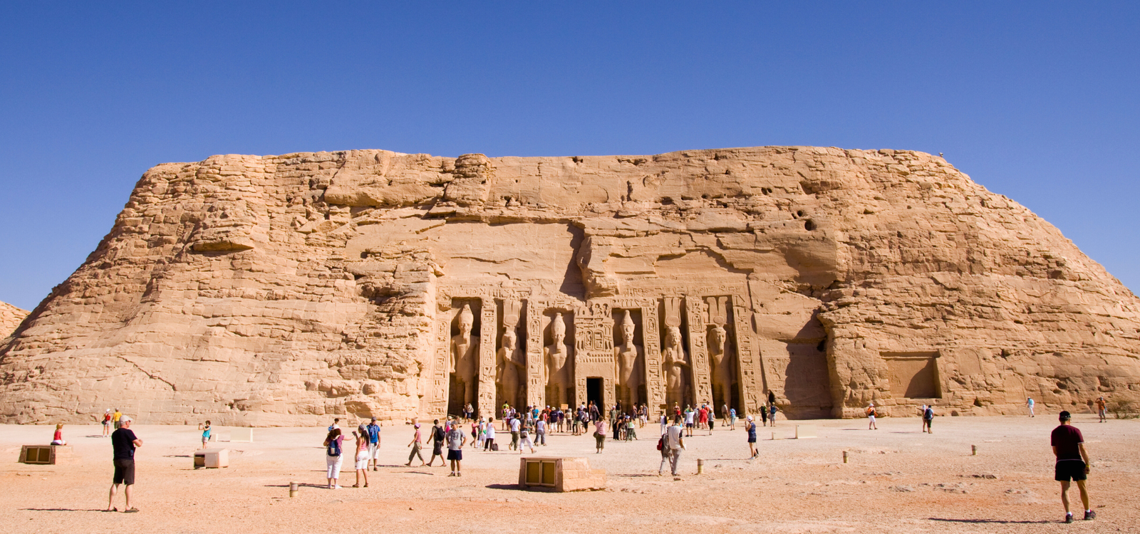 A photo of the Temple of Hathor and Nefertari, showcasing the colossal statues of Ramses II and Nefertari carved into the mountainside.