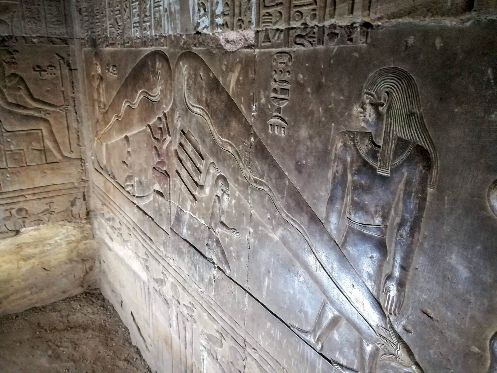 A photo of the Dendera Light relief, showing a hieroglyphic inscription and a depiction of a light bulb.