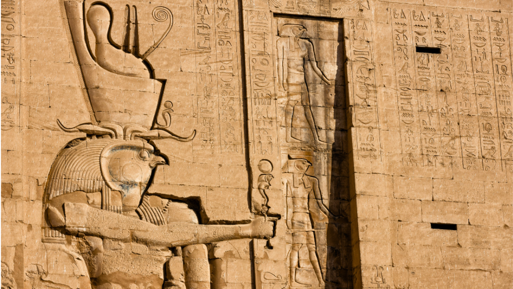 A relief carving of Horus, the falcon-headed god, on a temple wall in Egypt.