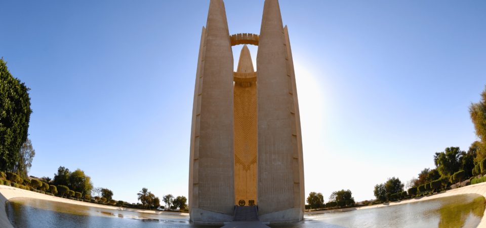 The Symbol of Friendship monument near the Aswan High Dam, featuring a tall structure with a circular design at the top.