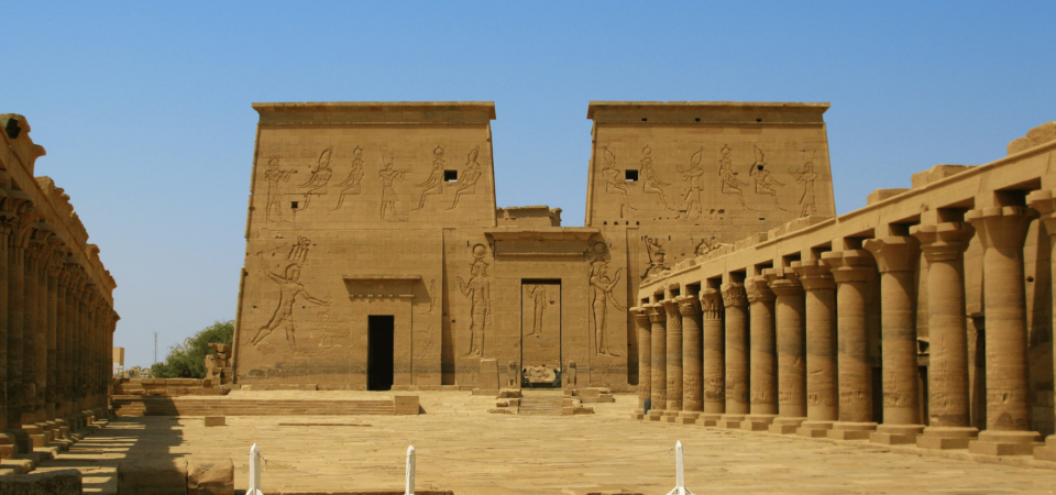 Front view of the Temple of Philae's main entrance, surrounded by intricately carved columns and ancient reliefs