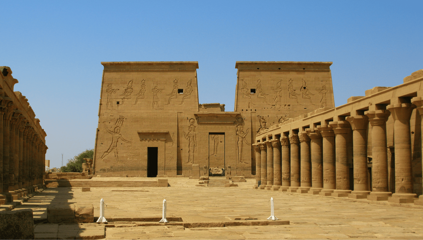 Front view of the Temple of Philae's main entrance, surrounded by intricately carved columns and ancient reliefs