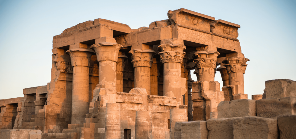 The Kom Ombo Temple illuminated by the warm glow of the setting sun.