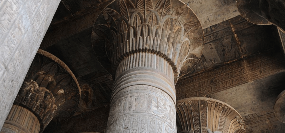 Close-up view of a decorated column at Esna Temple with intricate lotus carvings.