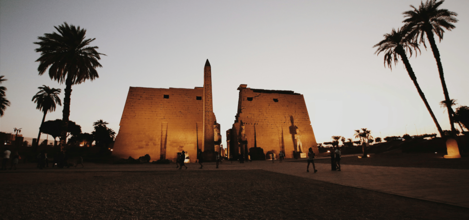 An iconic temple located in the city of Luxor, illuminated beautifully during the evening.