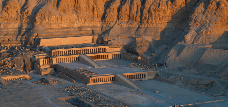 Temple of Hatshepsut nestled against cliffs in Deir el-Bahari, Egypt."