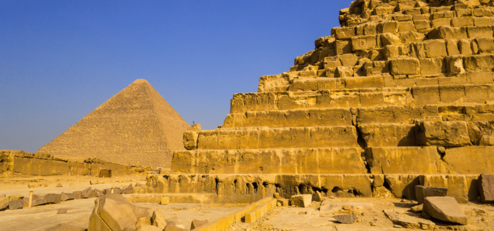 A view of the iconic Pyramids of Giza under a clear blue sky