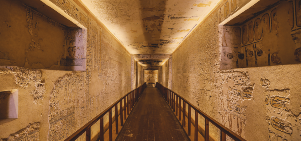 Tomb passageway in the Valley of the Kings adorned with intricate hieroglyphic carvings.