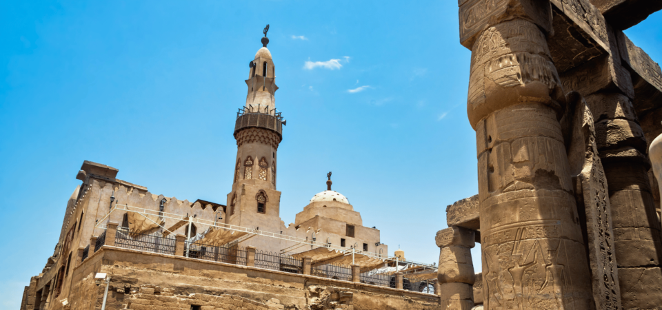 Luxor Temple's towering columns with the minaret of Abu al-Haggag Mosque in the background.