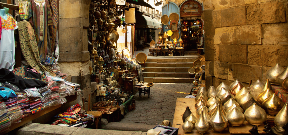 A traditional bazaar in Cairo filled with vibrant textiles, lanterns, and handcrafted goods.