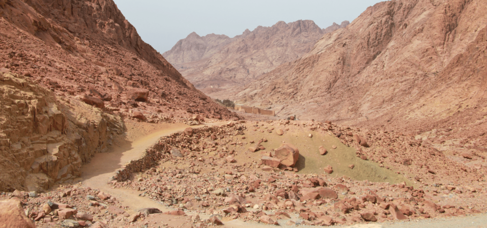 A rocky trail leading through the Sinai desert towards Saint Catherine's Monastery.