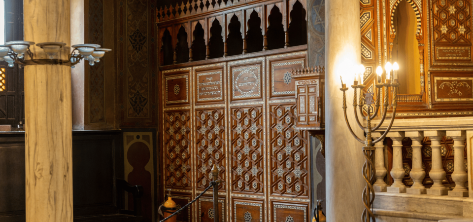 A serene interior view of the Ben Ezra Synagogue, highlighting its ornate wooden design